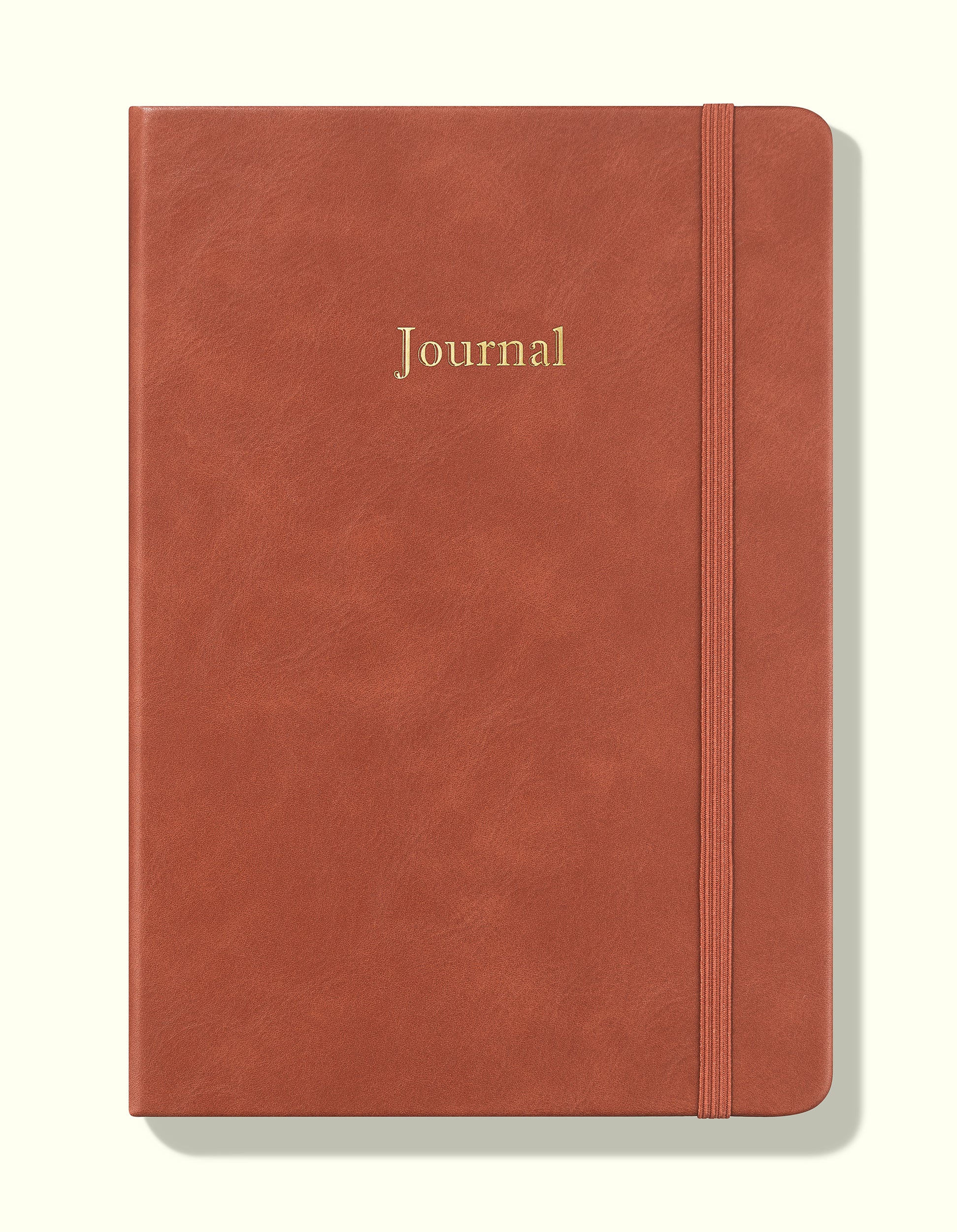 front cover of brown undated daily journal in a5 sitting on blank background