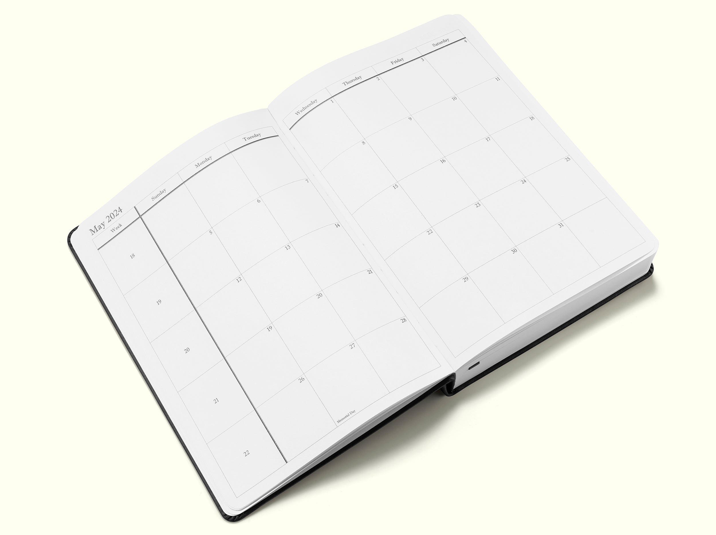planning pages of black 2024 daily journal in a5 sitting on blank background