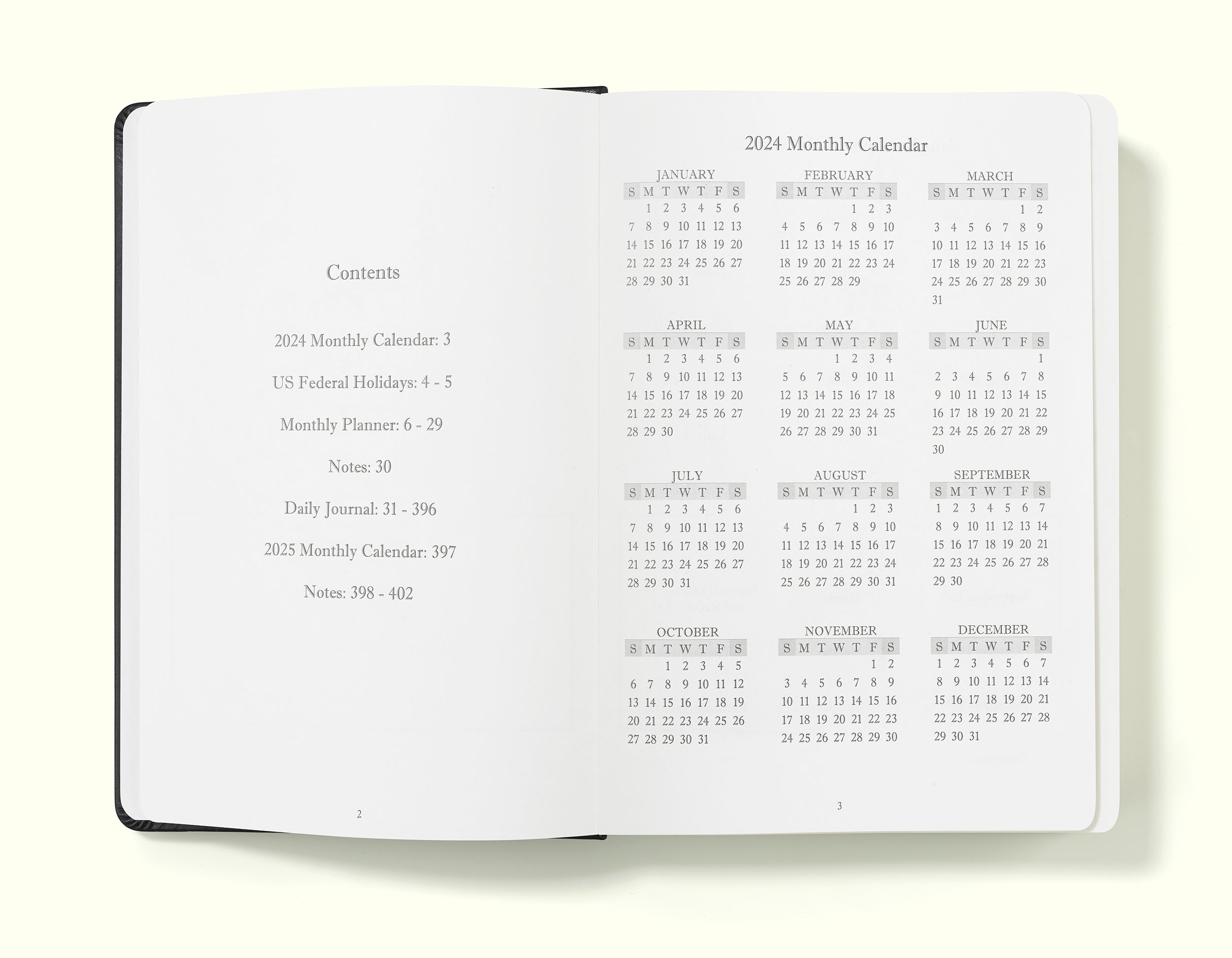 contents and calendar pages of black 2024 daily journal in a5 sitting on blank background
