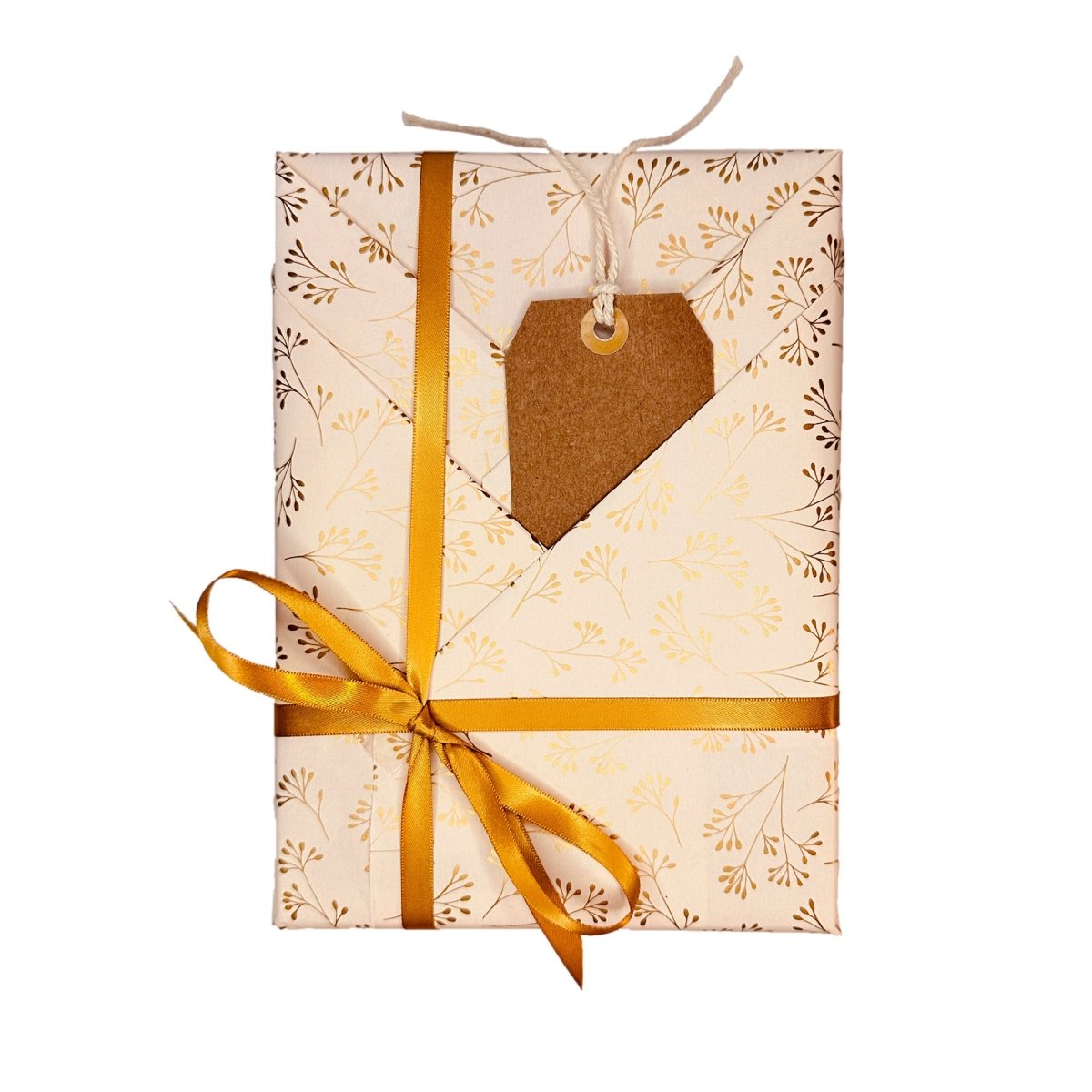 Cream gift wrapping paper with botanical pattern, gold ribbon and kraft tag