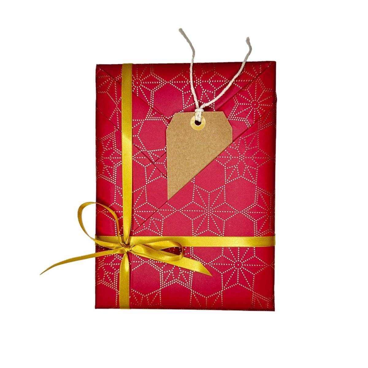 Crimson gift wrapping paper with gold ribbon and attached kraft price tag