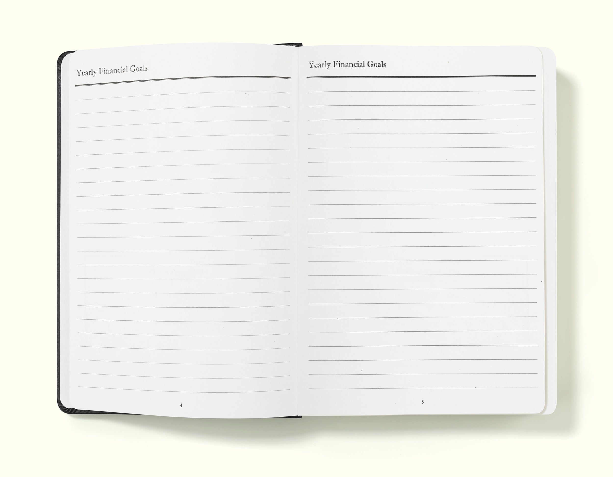 yearly goals pages of black financial planner and budgeting book in a5 on a blank background