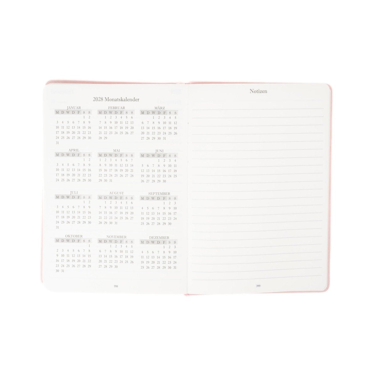 A5 executive journal open with monthly calendar on left and ruled notes on right, red binding