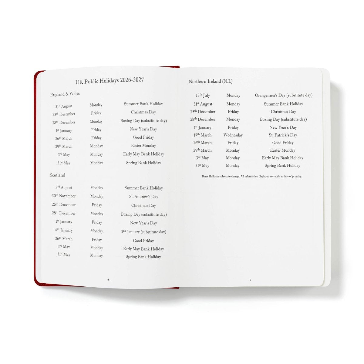 Executive journal open to holiday list pages with red binding along the edge