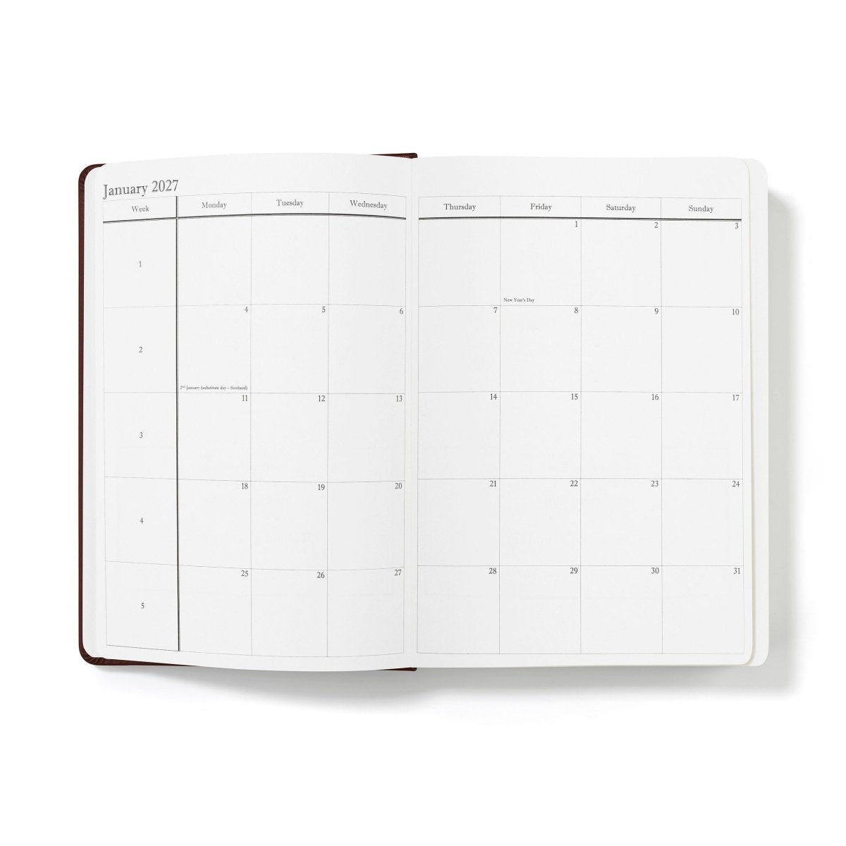 Open January 2027 planner pages with large weekday grid, white paper and dark brown edge trim