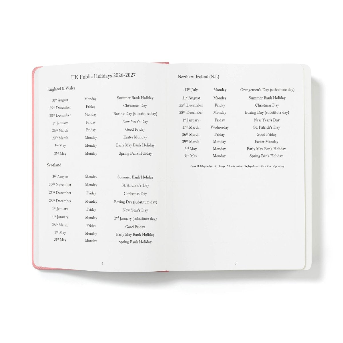 Executive journal open to holiday listings page with pink binding edge
