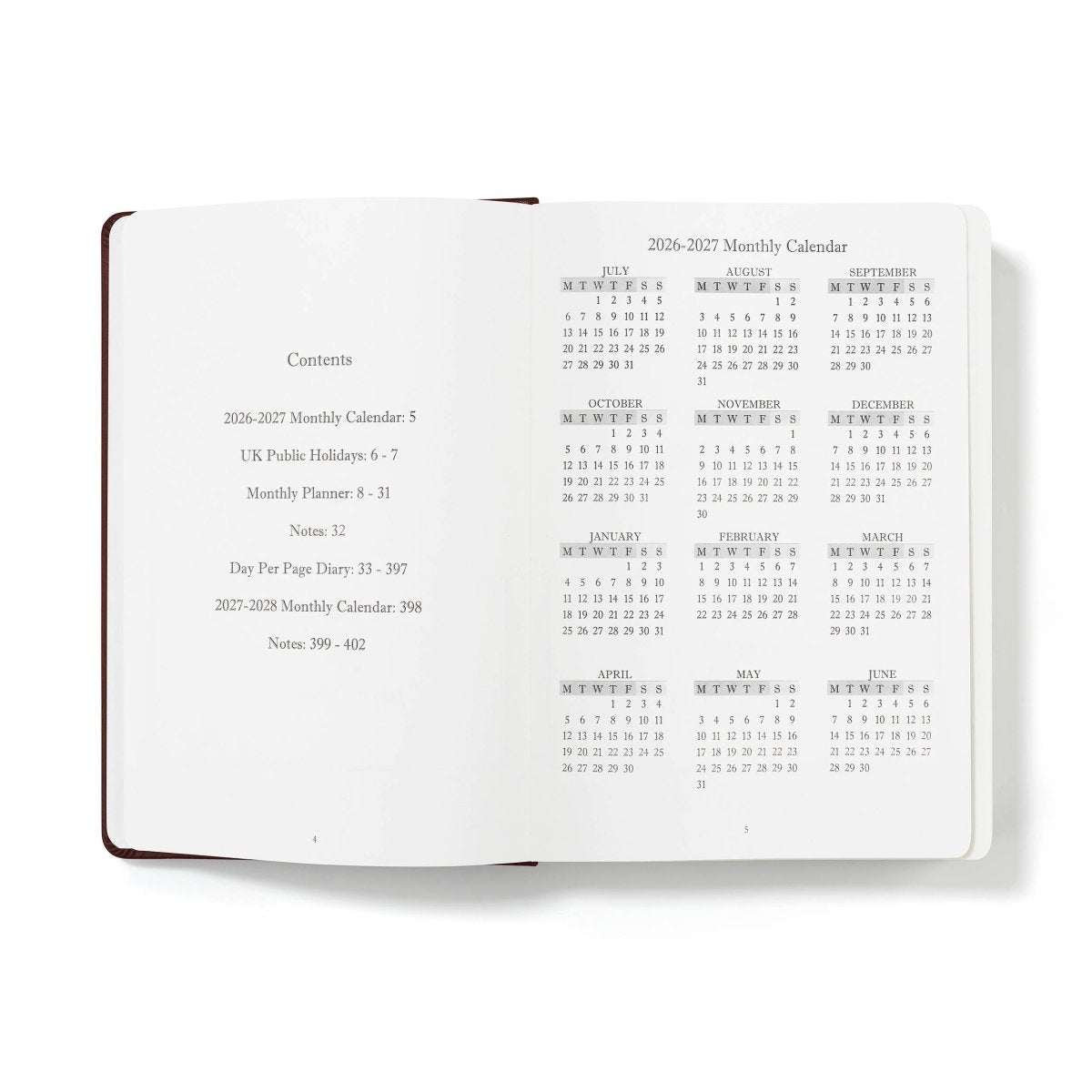 Open journal pages showing contents panel and monthly calendar boxes, white paper with brown binding
