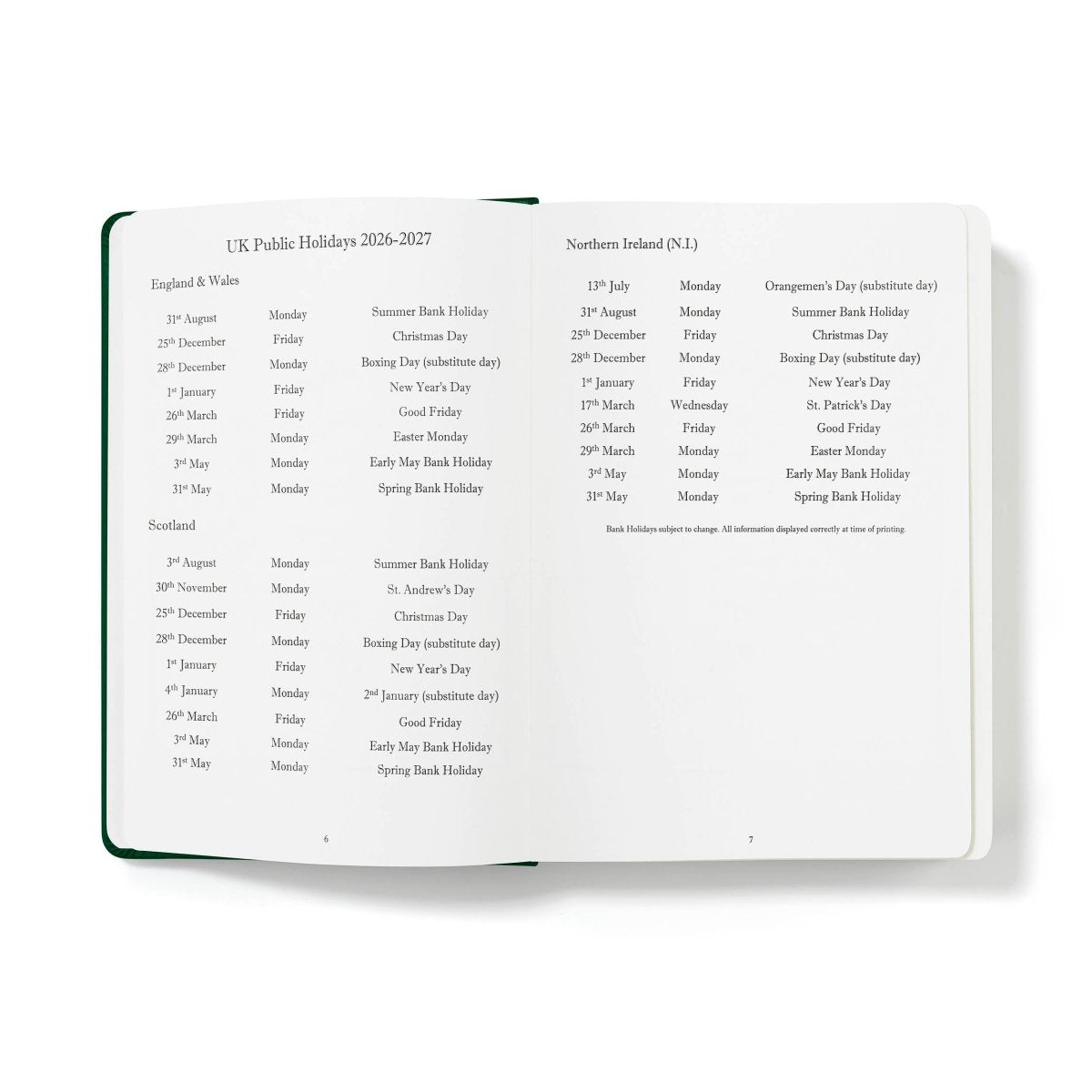Executive journal open to holiday listings page with dark green binding edge