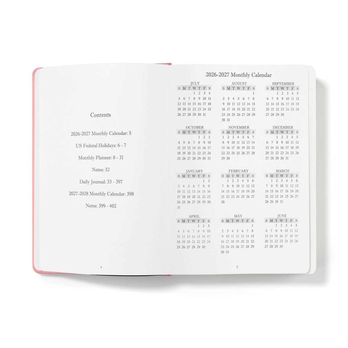 Pink-edged open planner showing monthly calendar contents pages