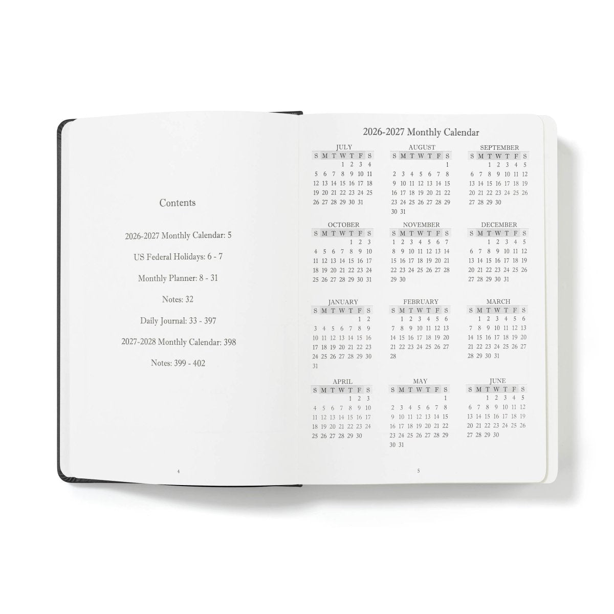 Executive journal open showing contents and monthly calendar grids on white pages