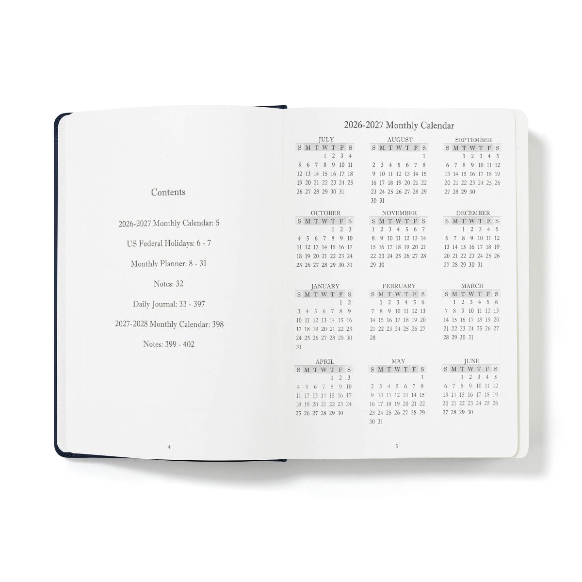 Executive journal open showing contents and monthly calendar section on white pages