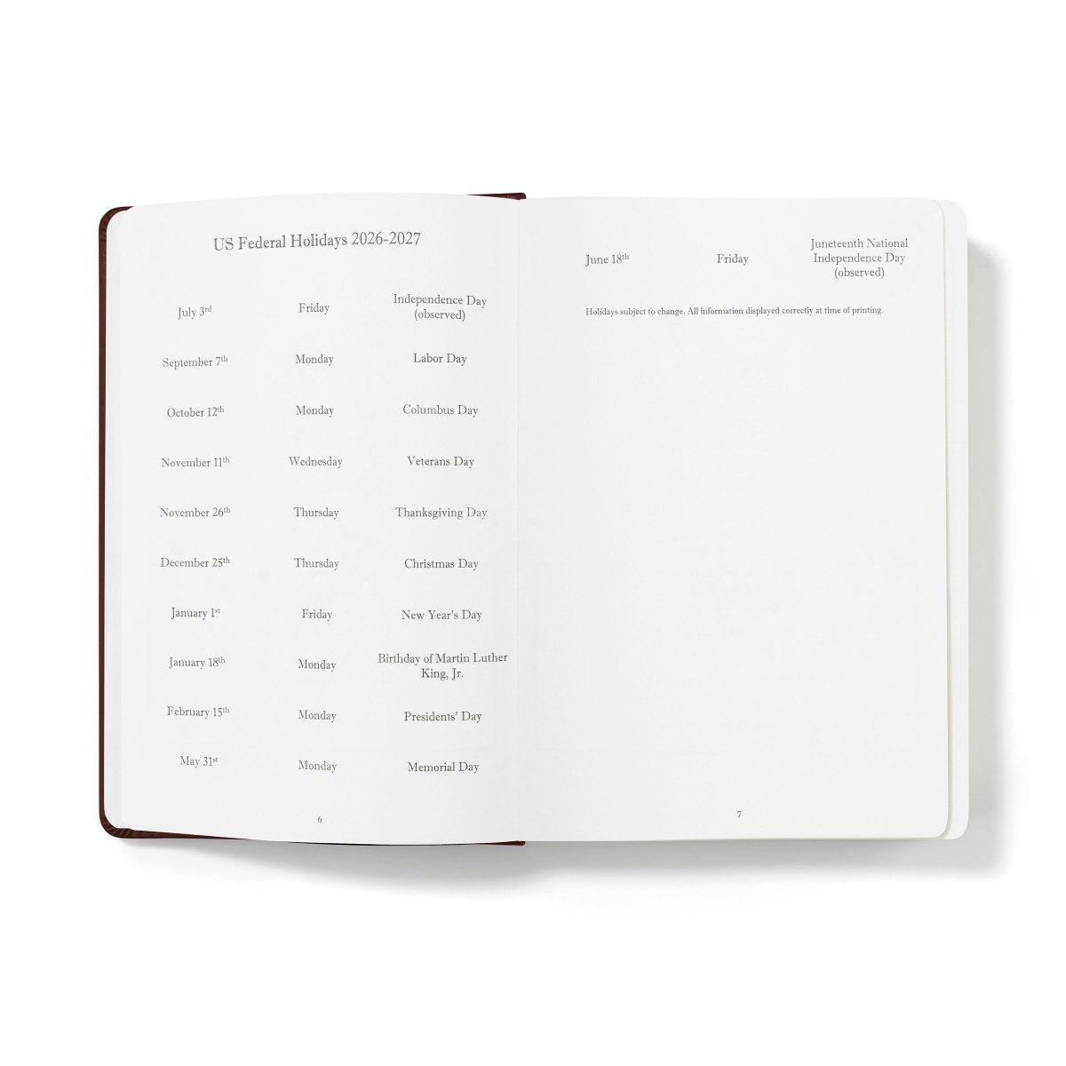 Mid-year planner open to US federal holiday list, printed on white pages with brown binding