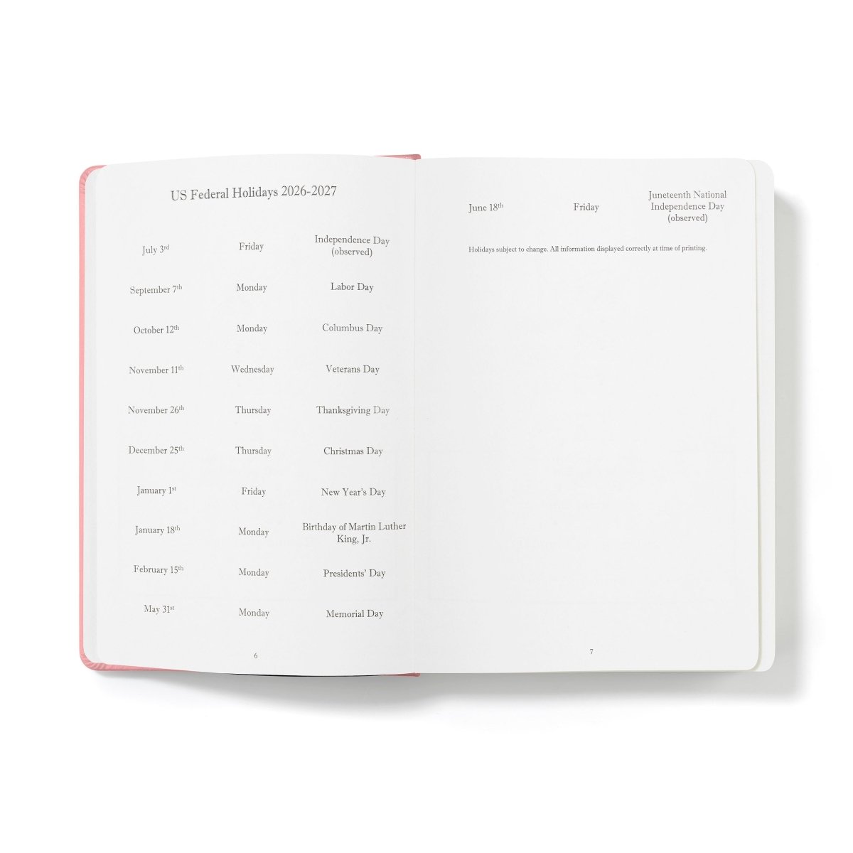 Pink-edged open planner displaying US federal holiday list pages