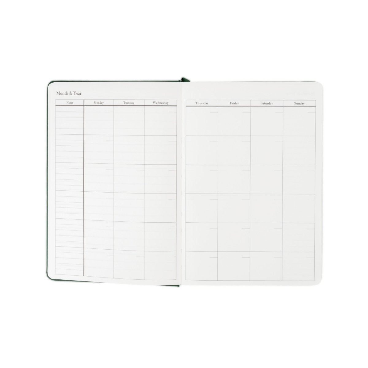 Undated executive journal open to month overview calendar grid with green borders