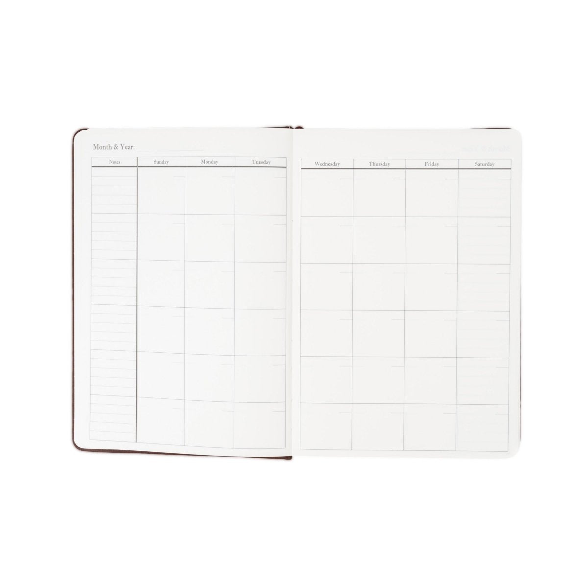 Undated weekly planner journal opened flat with monthly calendar layout grid.