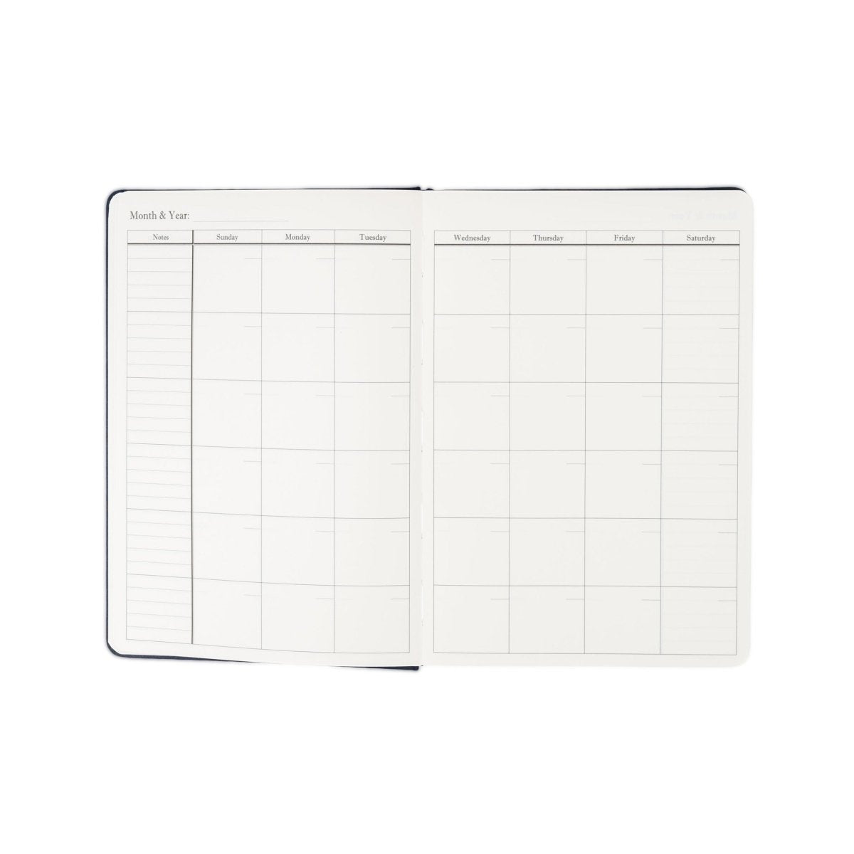 Undated weekly planner journal opened flat with monthly calendar grid pages.
