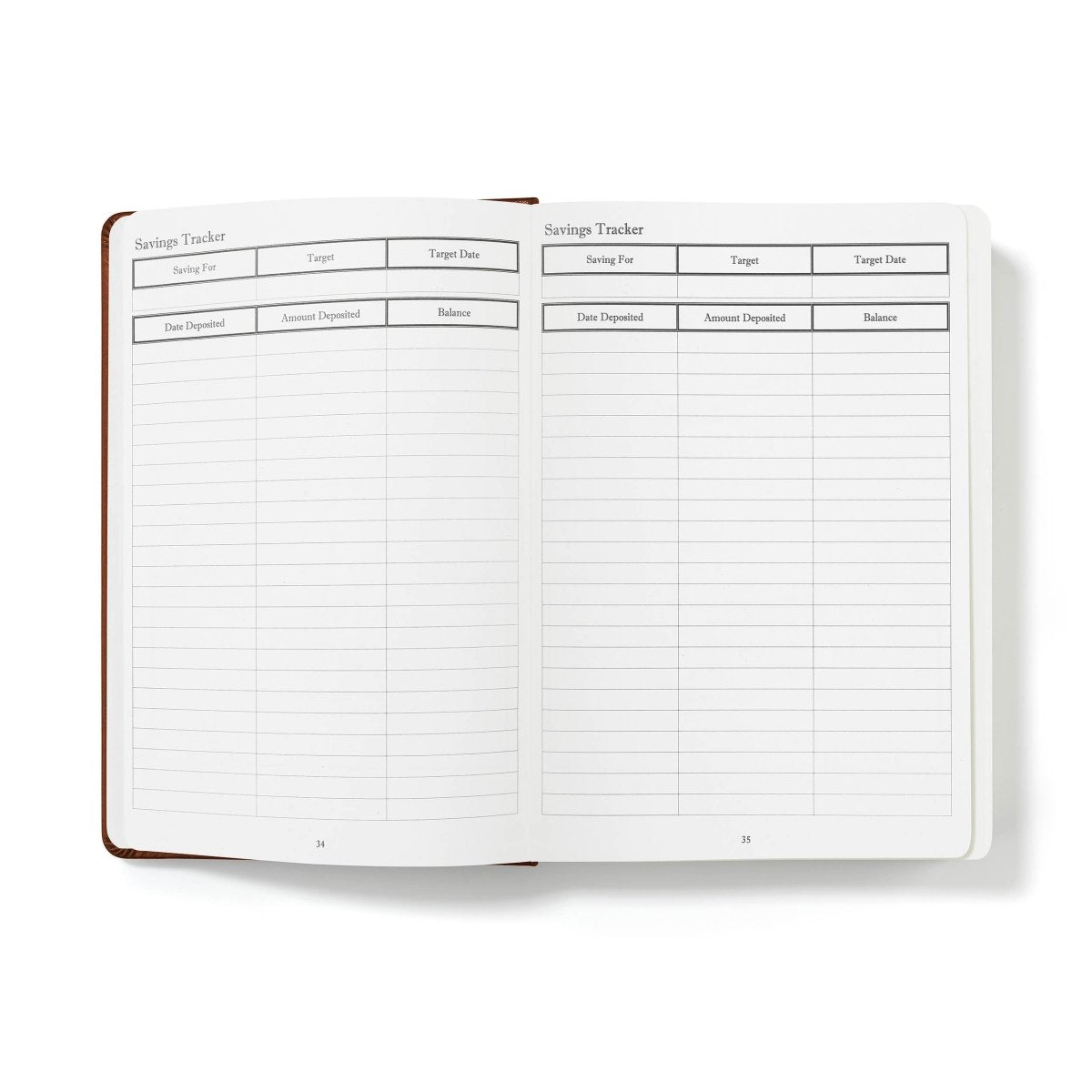 Open financial planner journal with Savings Tracker tables and date fields