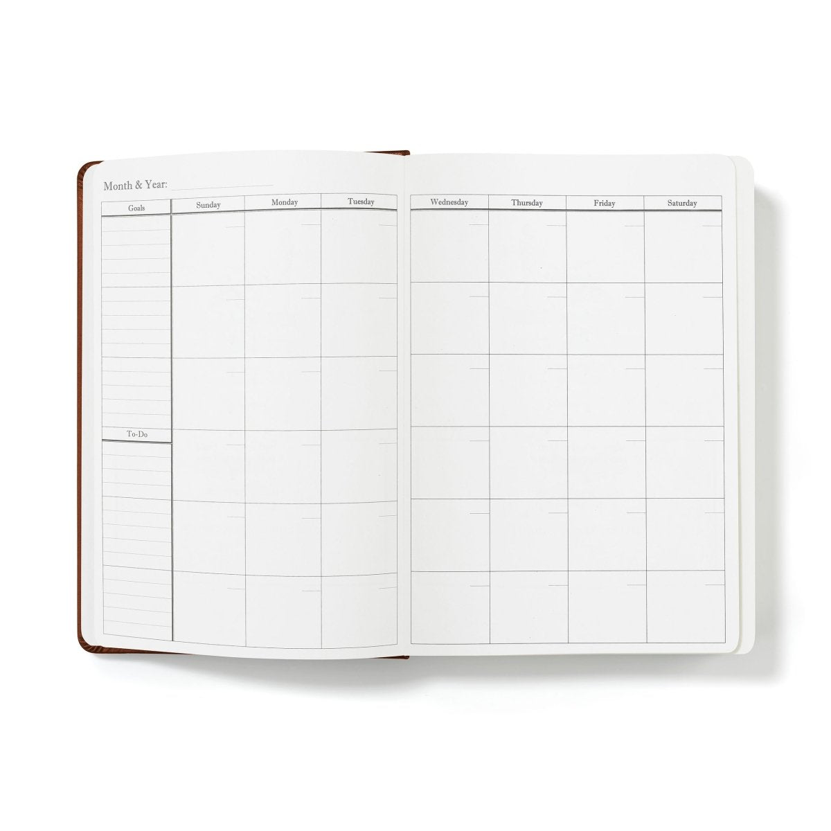 Monthly budget planner pages with weekly grid layout, open journal with brown spine