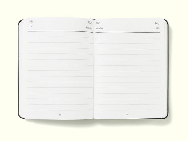 day per page diary pages of black 2024 daily journal in a6 sitting on blank background