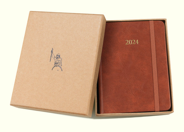 brown 2024 daily journal in a6 with gift box sitting on blank background