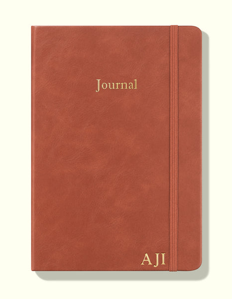 front cover of brown undated daily journal in a5 with personalization sitting on blank background
