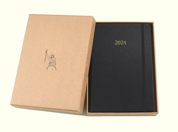 black 2024 daily journal in a5 with gift box sitting on blank background