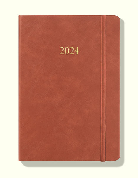 front cover of brown 2024 daily journal in a5 sitting on blank background