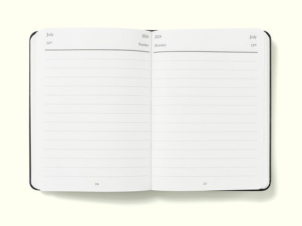 daily planner pages of black 2024 daily journal in a6 sitting on blank background