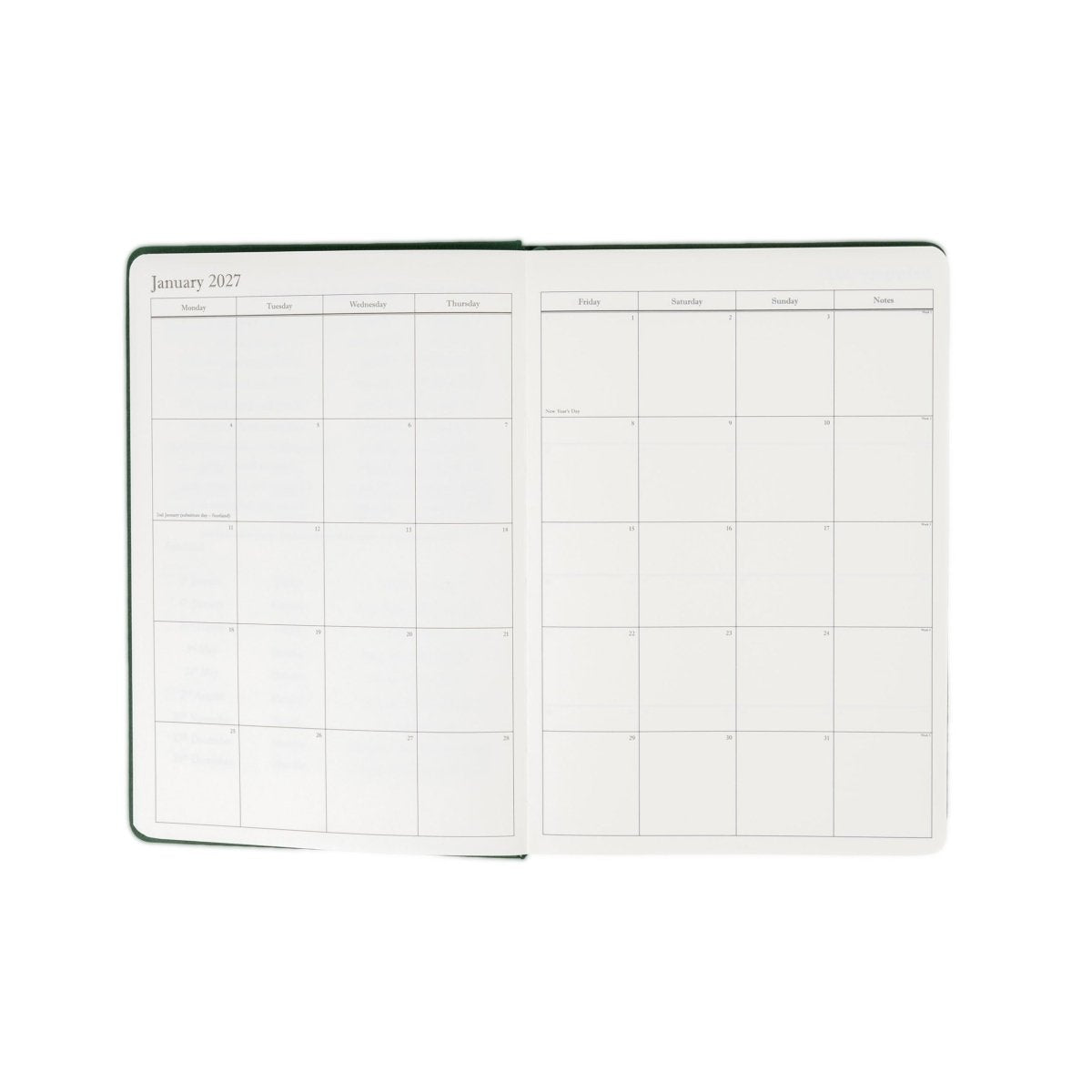Planner interior open spread with green-trim monthly calendar grid pages