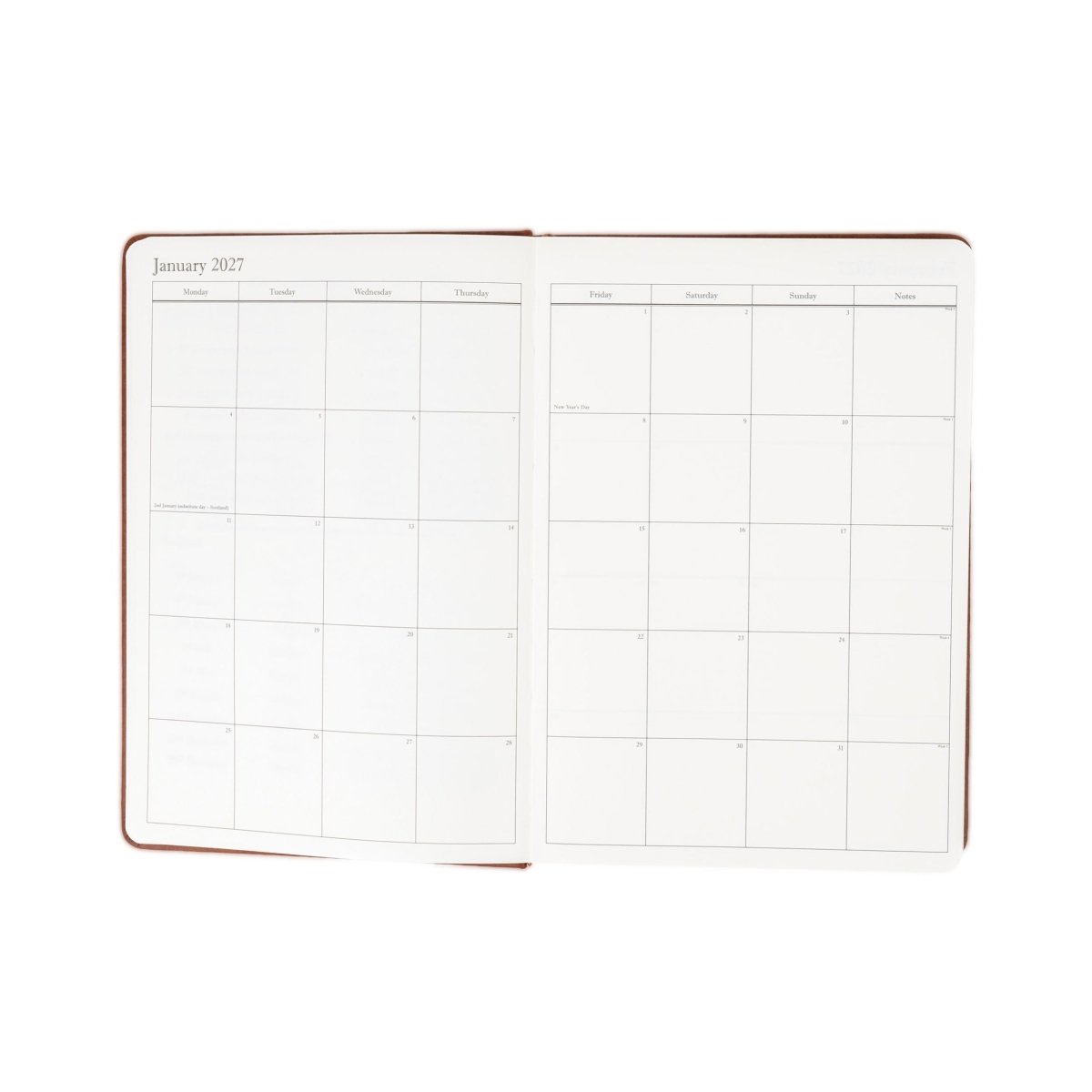 Brown-trimmed 2027 executive journal open to monthly calendar grid pages.
