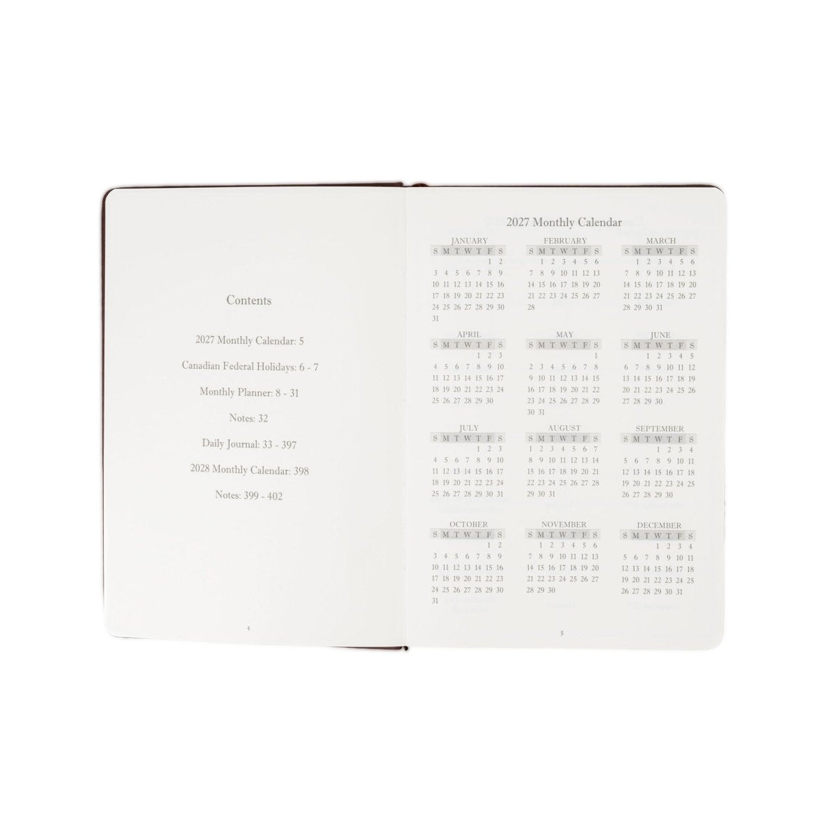 Open 2027 monthly calendar journal with white pages and lined notes on the right