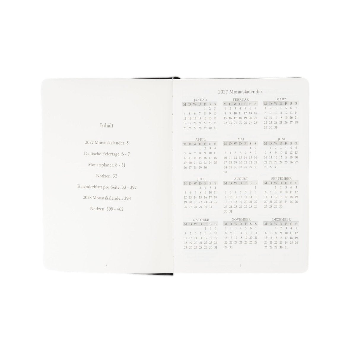 A5 executive journal open spread with contents list and 2027 calendar tables, dark green edge