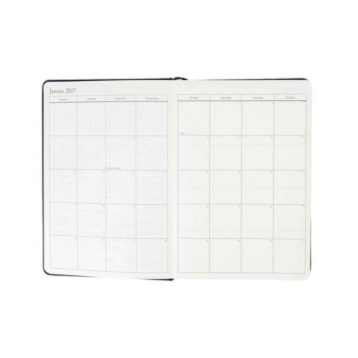 Executive journal planner open to weekly schedule pages, deep blue cover, 2027 layout.