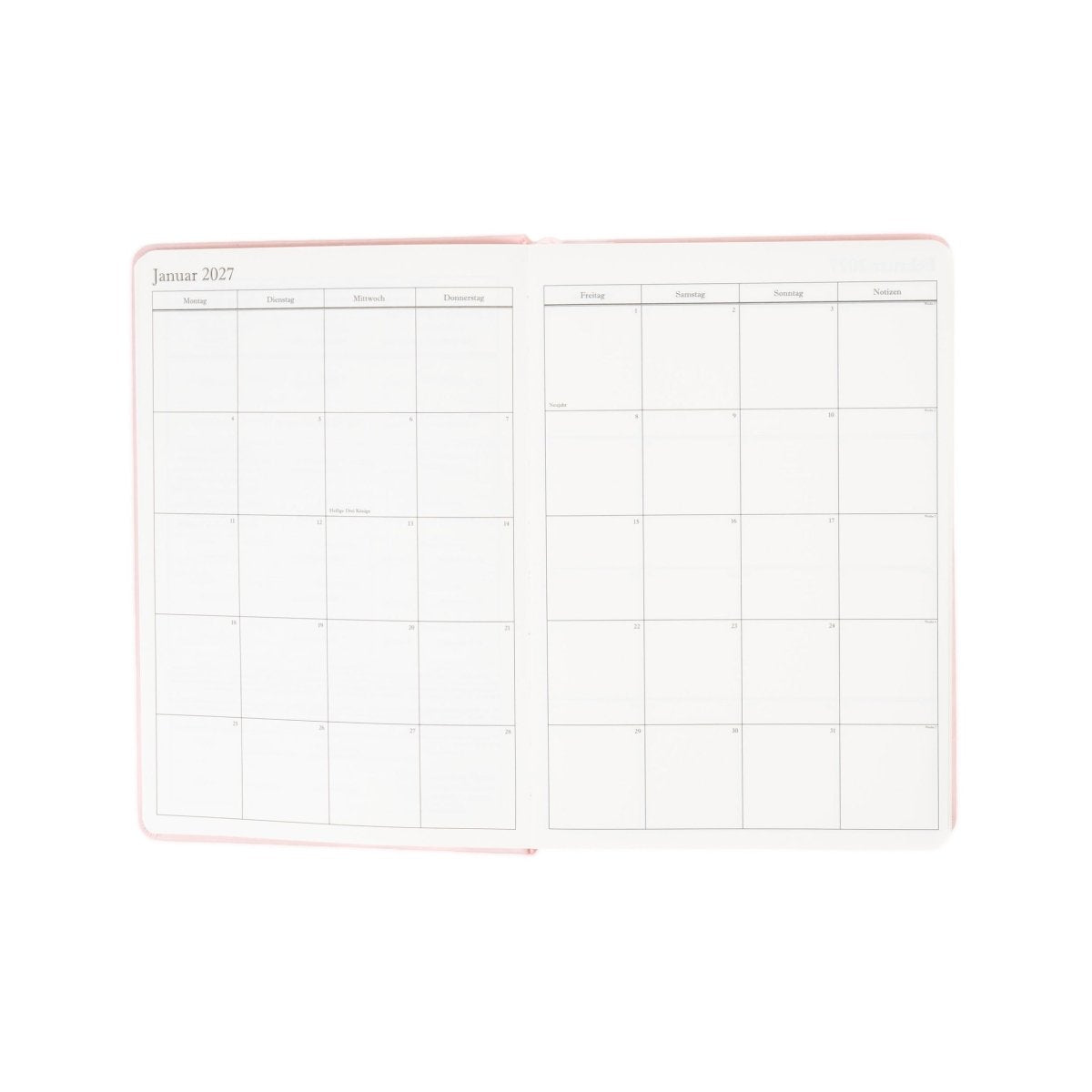 Open planner spread with monthly date grid tables on white pages
