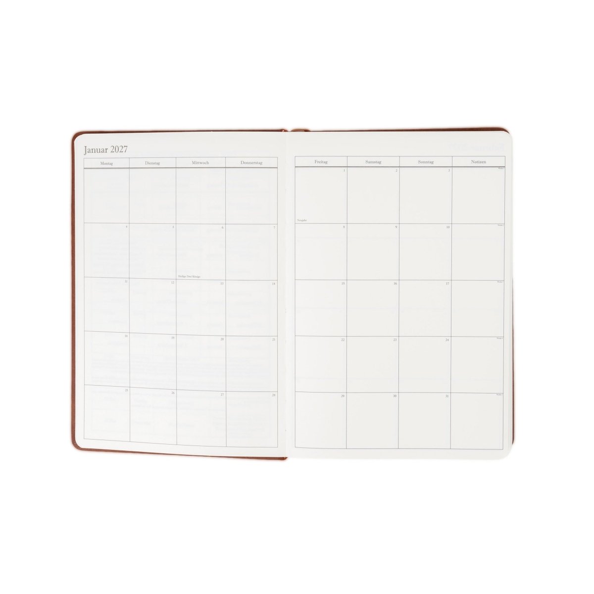 Executive journal planner open to weekly schedule pages, chestnut brown cover, 2027 layout.