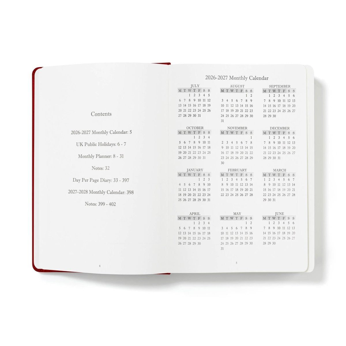 Executive journal open to monthly calendar pages with printed holidays and contents list