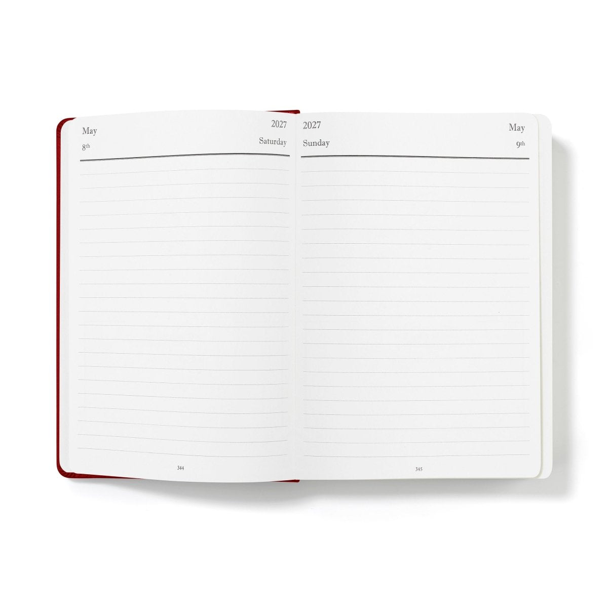 Executive journal open to weekly planning pages with date headings and red page edges