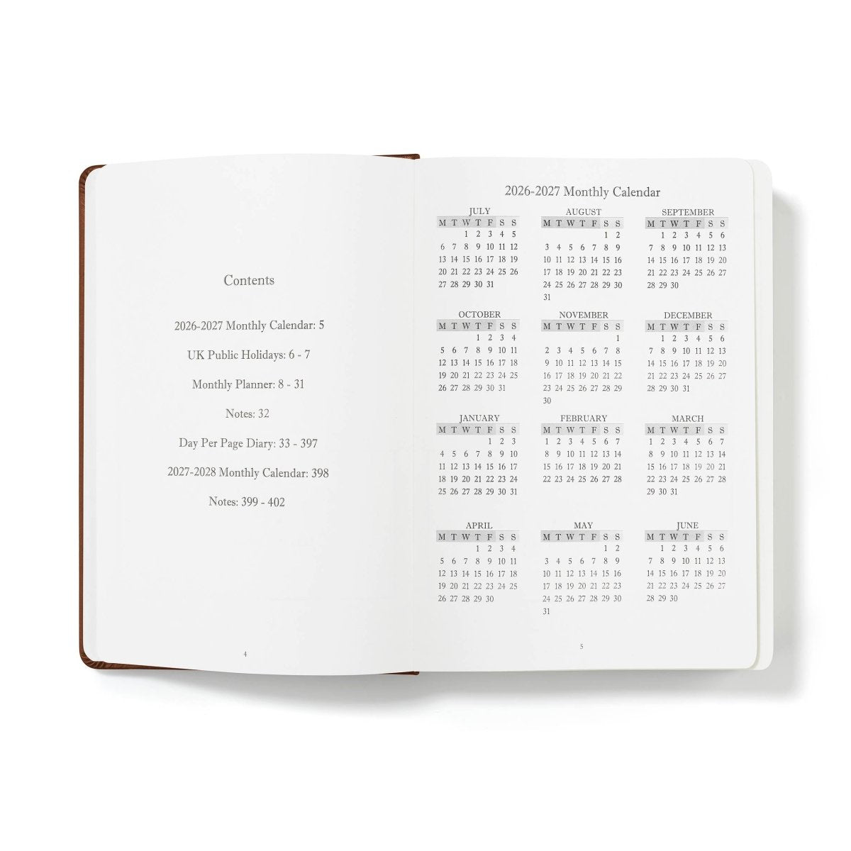 Open journal pages with contents list and monthly calendar grids, white paper, dark brown edge trim