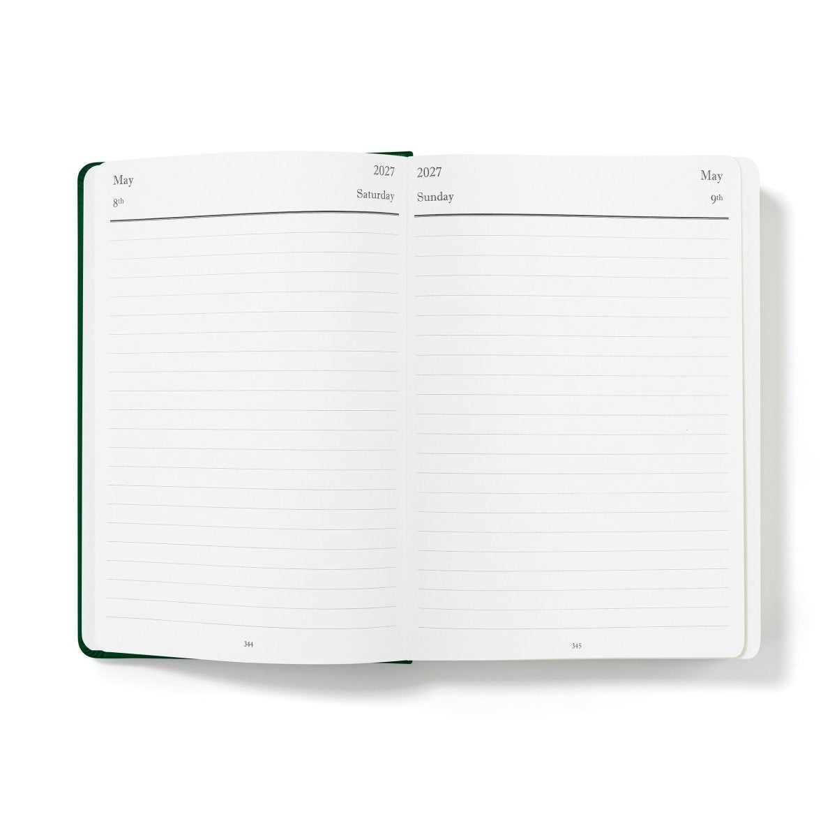 Executive journal open to lined monthly planner pages with dark green outer edge