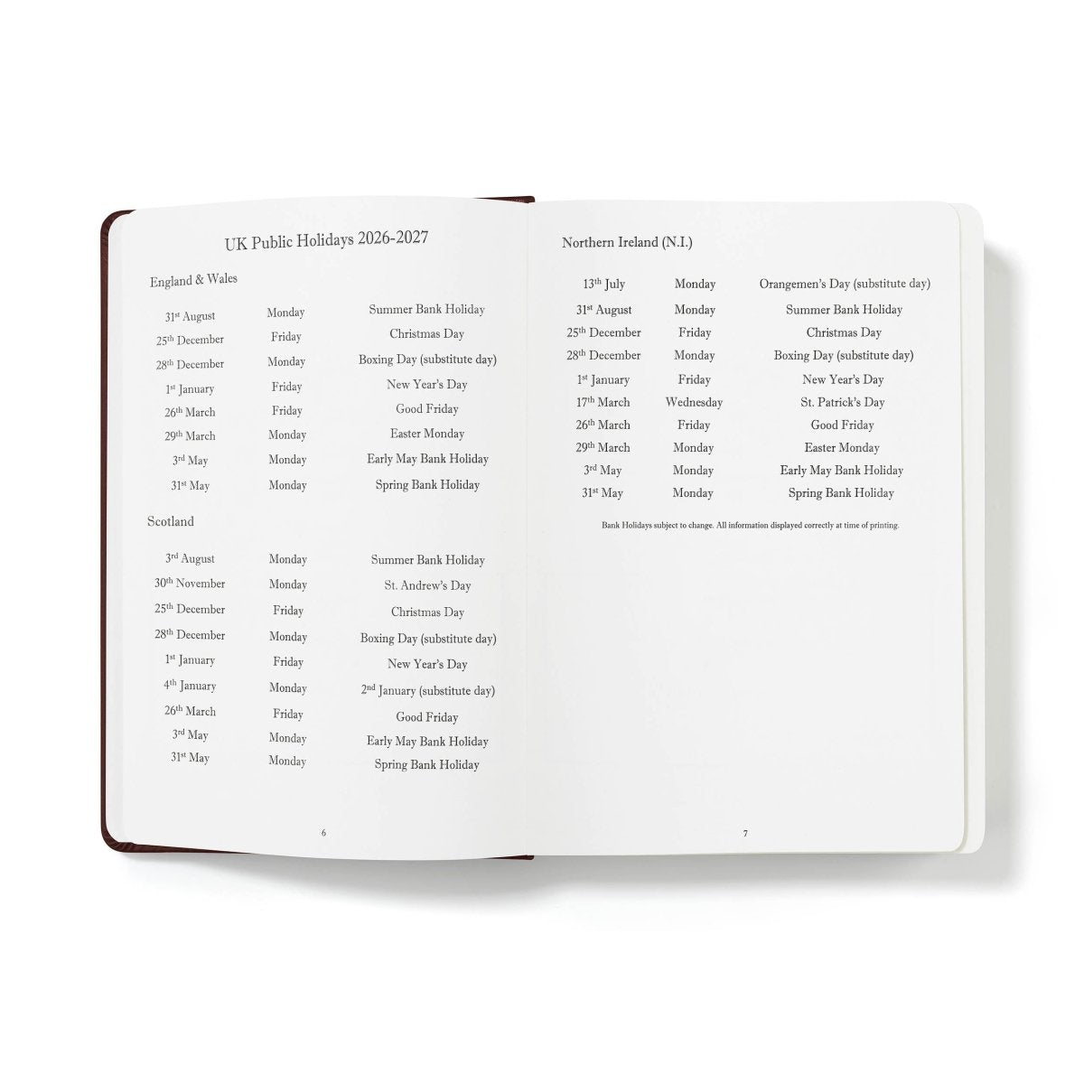 Open holiday calendar pages with multiple regional entries and date listings, white paper