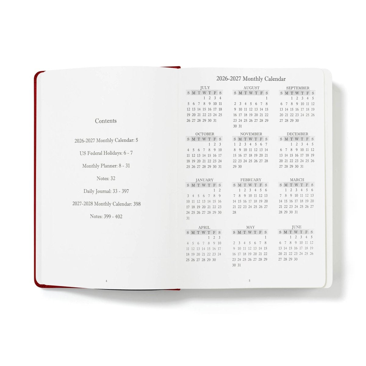 Open monthly calendar journal with white pages and red binding edge, 2026–2027 visible