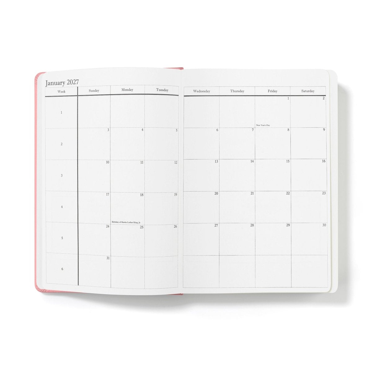 Pink-edged open planner with January monthly calendar grid