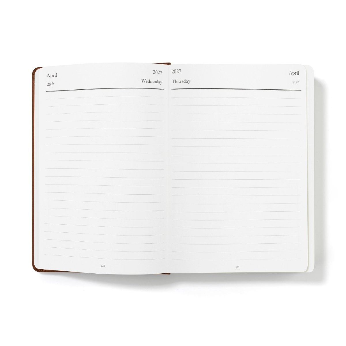Mid-year planner open to blank monthly writing pages, white paper with brown binding
