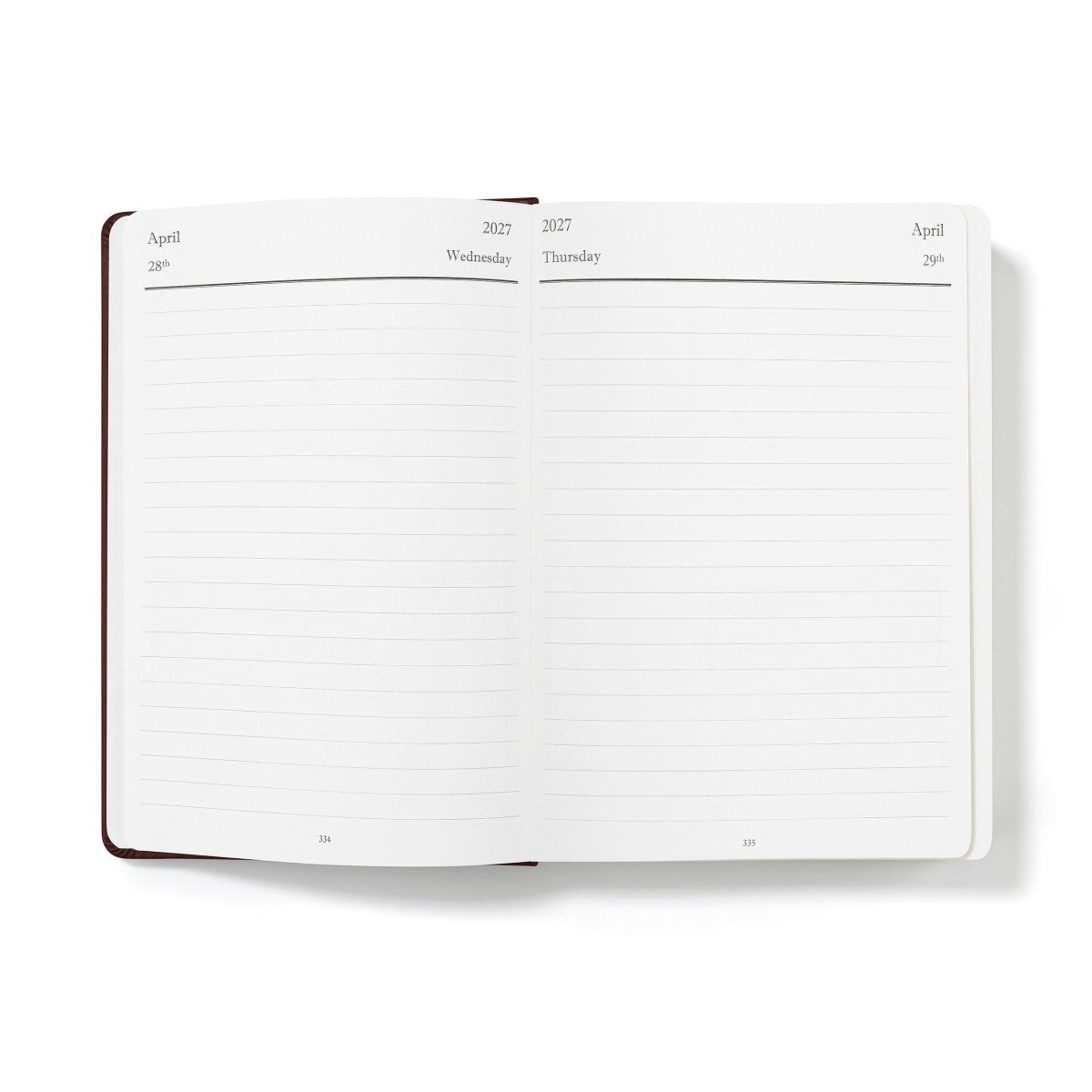 Mid-year planner open to blank monthly writing pages, white paper with brown binding