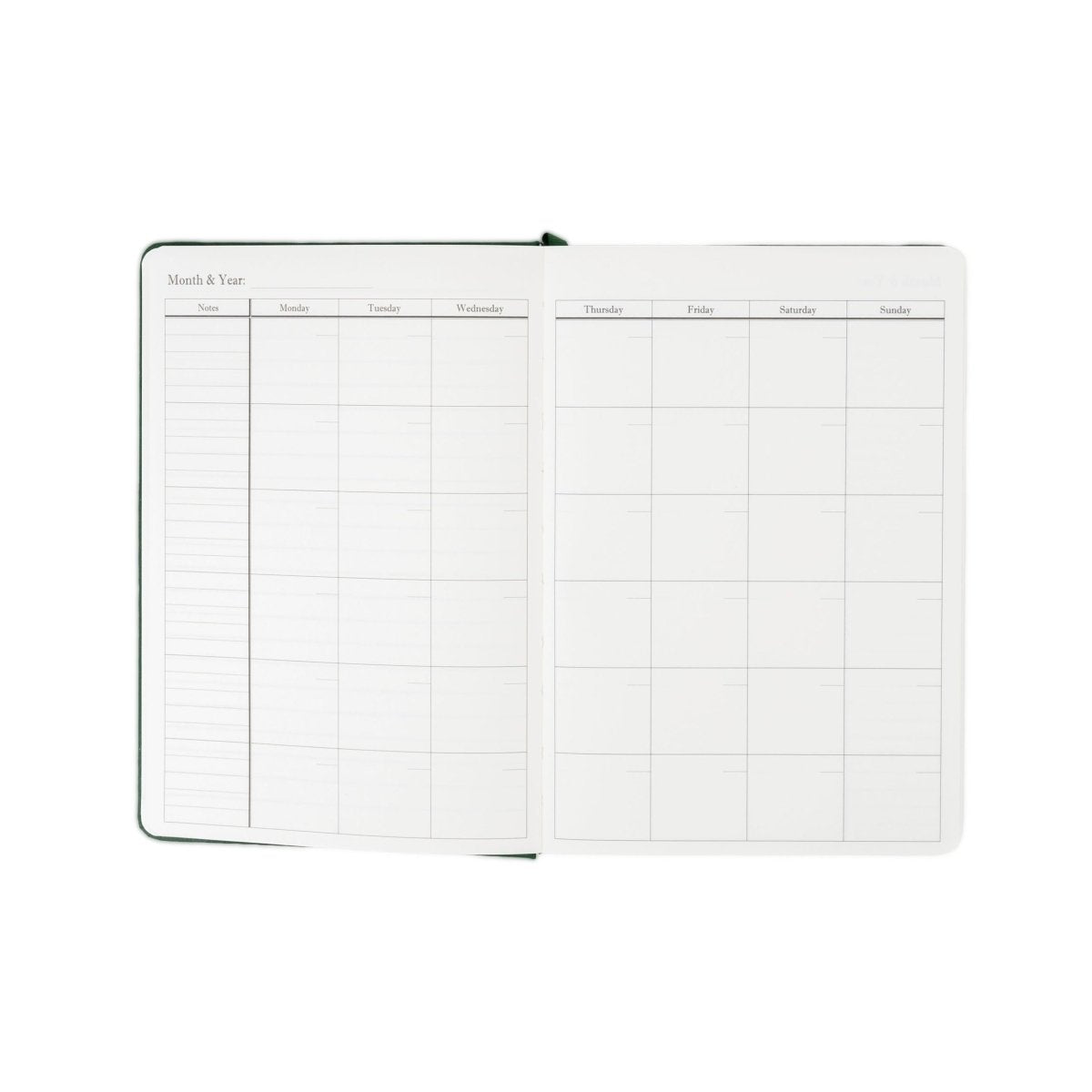Undated planner journal opened to monthly and weekly grid pages, green cover.