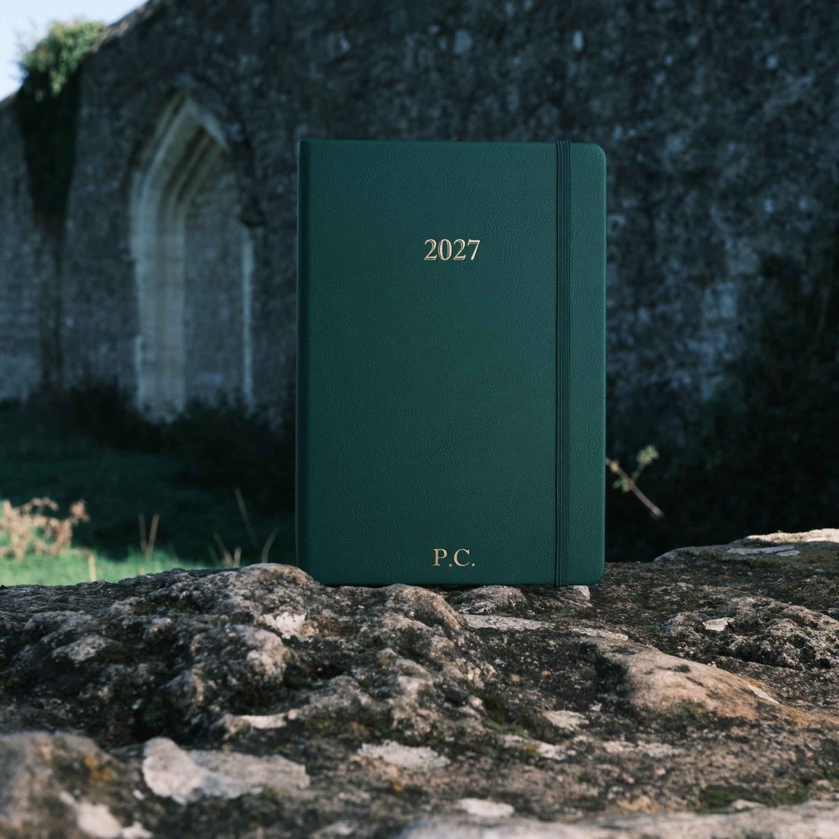 Green 2027 weekly journal with “P.C.” initials on the cover