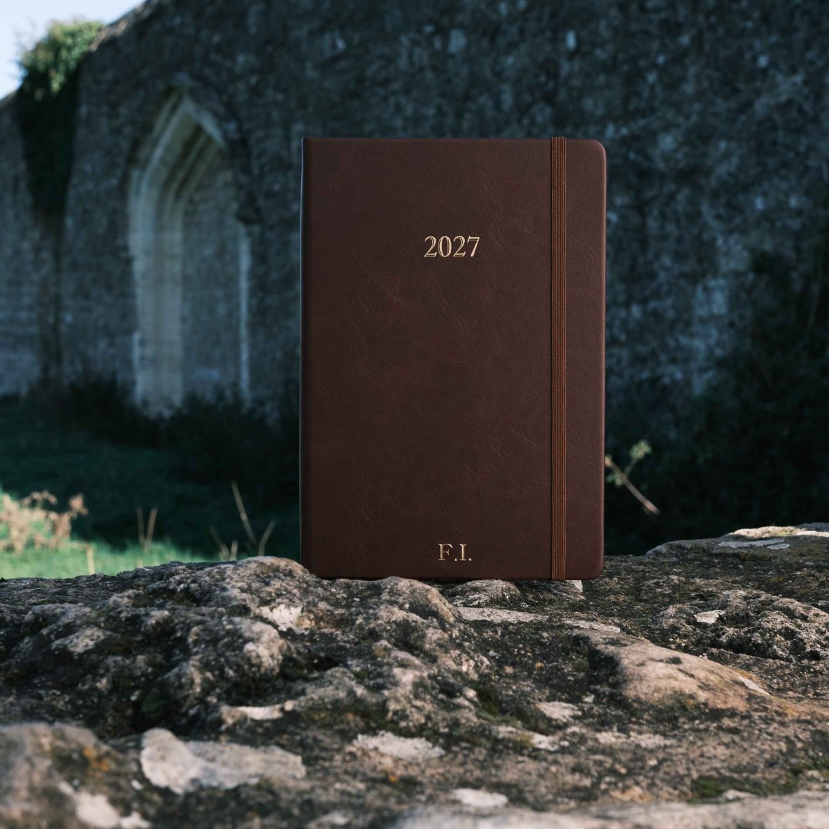 Brown 2027 weekly journal with “F.I.” initials on the cover