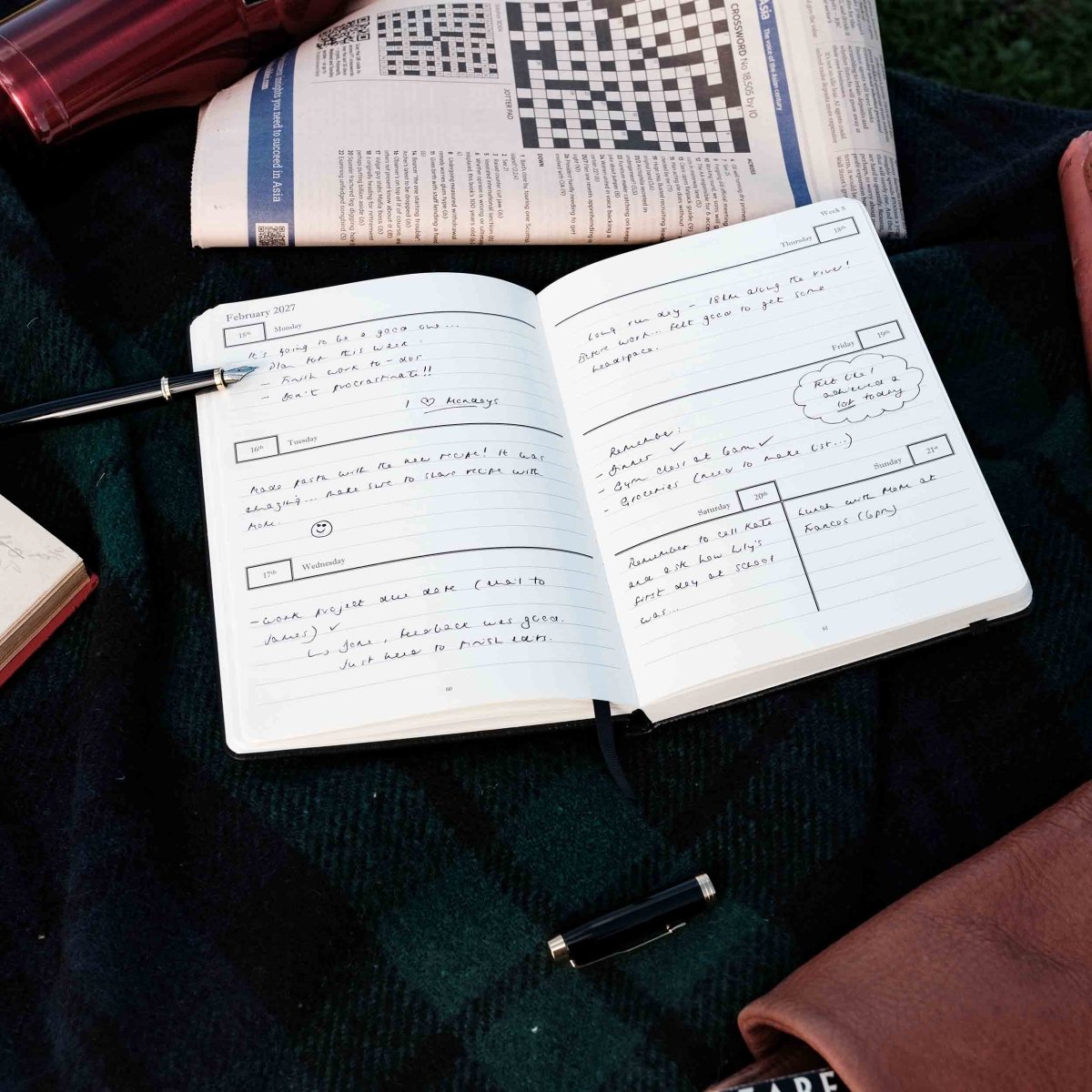 Weekly journal open to handwritten daily entries and notes